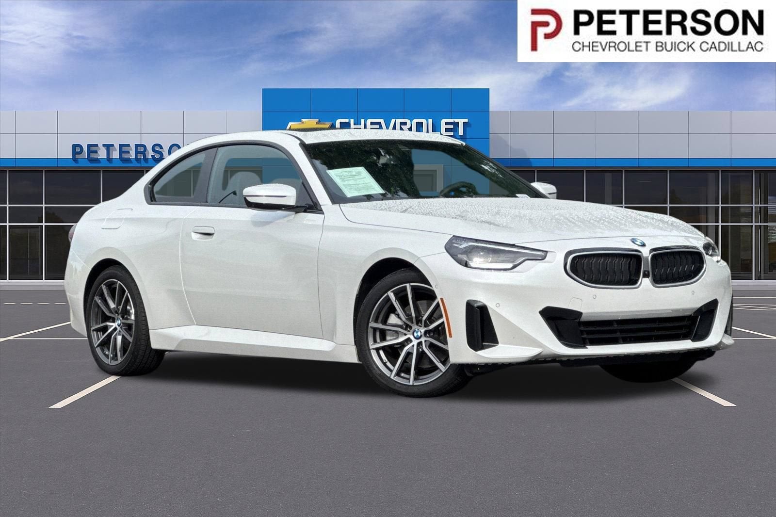 2025 BMW 230i xDrive in White — front three-quarter view